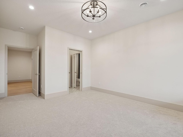 5010 Millie Rd SW, Rochester, MN 55902 - unfurnished bedroom with recessed lighting, a notable chandelier, light carpet, and visible vents