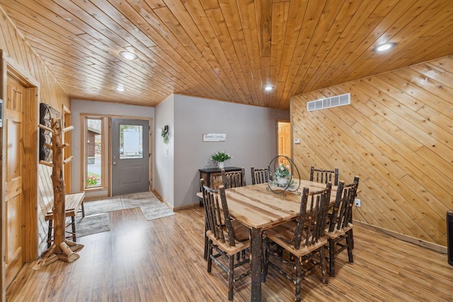 dining room with visible vents, recessed lighting, light wood-style flooring, and wooden ceiling