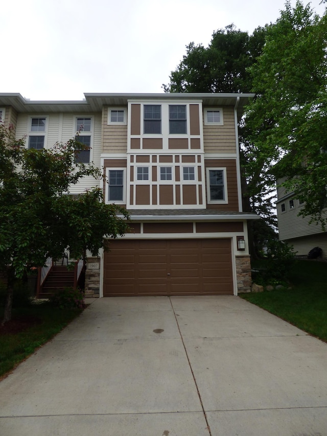 1907 Red Maple Ln, Northfield, MN 55057 - view of front of home featuring stone siding, a garage, driveway, and stairs