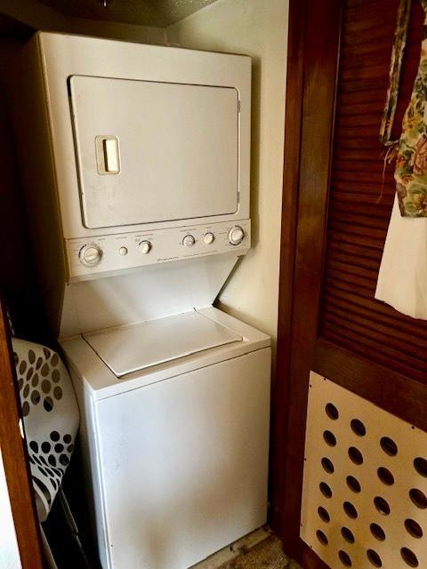 laundry room featuring stacked washer and dryer and laundry area