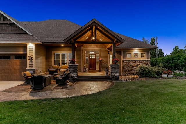 3420 Fairview Ave N, Arden Hills, MN 55112 - view of exterior entry with a lawn, a garage, concrete driveway, a shingled roof, and stone siding