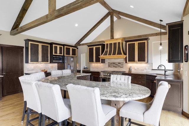 3420 Fairview Ave N, Arden Hills, MN 55112 - kitchen featuring appliances with stainless steel finishes, a large island, a sink, light wood finished floors, and beamed ceiling