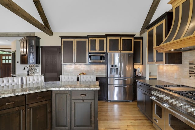 3420 Fairview Ave N, Arden Hills, MN 55112 - kitchen with stainless steel appliances, wall chimney exhaust hood, tasteful backsplash, and light wood-type flooring