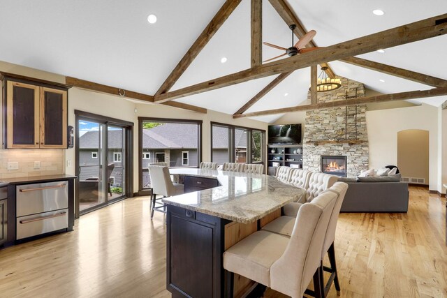 3420 Fairview Ave N, Arden Hills, MN 55112 - kitchen featuring a kitchen breakfast bar, recessed lighting, light wood-style flooring, beam ceiling, and high vaulted ceiling