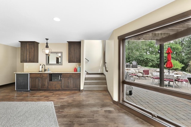 3420 Fairview Ave N, Arden Hills, MN 55112 - kitchen featuring dark brown cabinets, a sink, light countertops, dark wood finished floors, and recessed lighting