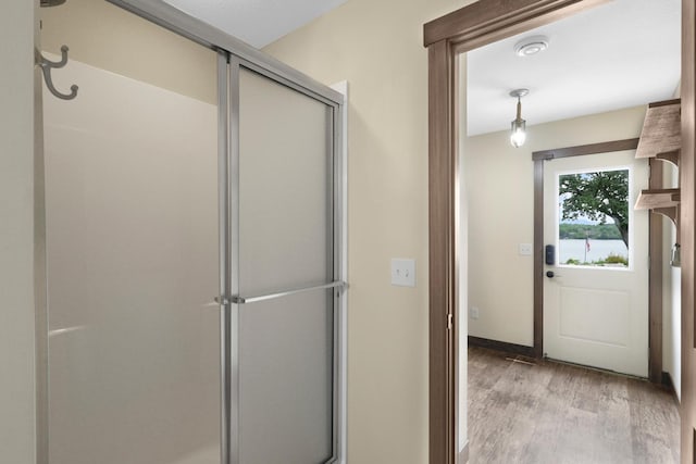 3420 Fairview Ave N, Arden Hills, MN 55112 - full bathroom with wood finished floors, a stall shower, and baseboards