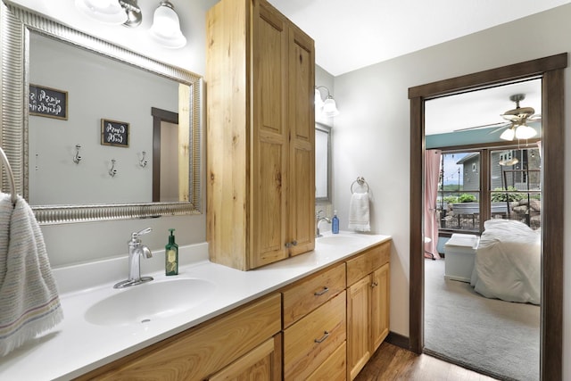 3420 Fairview Ave N, Arden Hills, MN 55112 - full bathroom featuring double vanity, a ceiling fan, wood finished floors, and connected bathroom