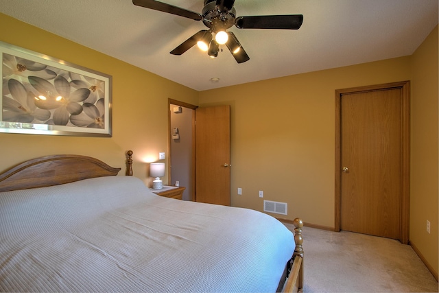 bedroom with a ceiling fan, baseboards, visible vents, and light carpet
