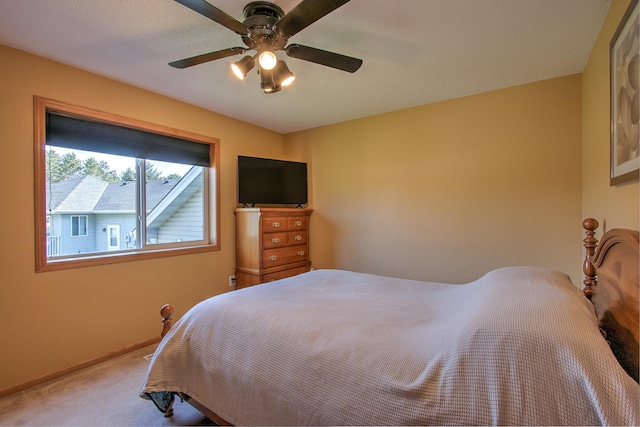 bedroom with baseboards, carpet flooring, and a ceiling fan