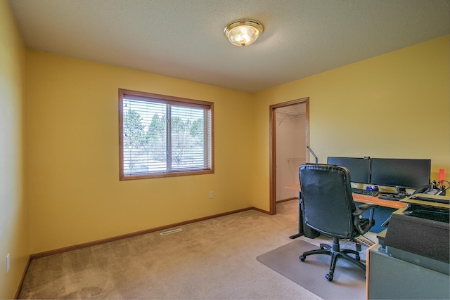 carpeted office with baseboards and visible vents