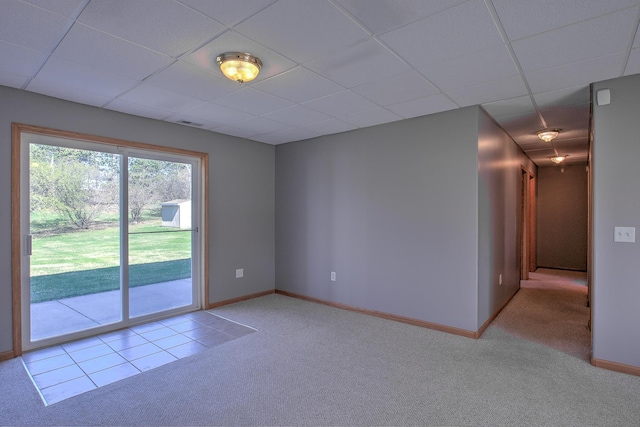 unfurnished room with light colored carpet, a paneled ceiling, baseboards, and visible vents