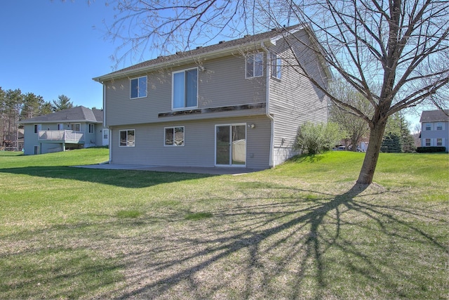 back of house featuring a yard