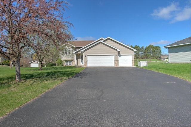 view of front of house with a garage, a front yard, and aphalt driveway