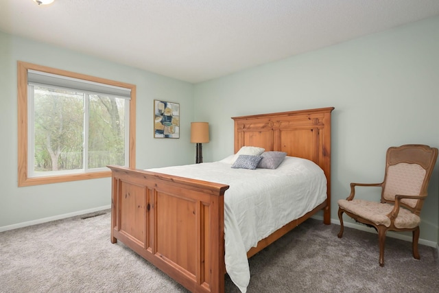 bedroom featuring light carpet and baseboards
