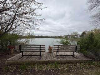 view of community featuring a deck with water view