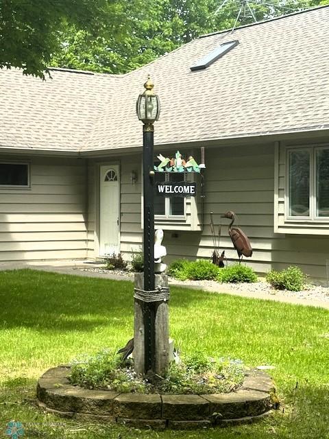 38227 County Highway 34, Maple Grove Twp, MN 56569 - property entrance featuring a shingled roof and a lawn
