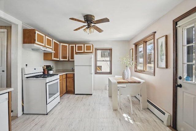 kitchen featuring white appliances, a baseboard radiator, brown cabinetry, light countertops, and a ceiling fan