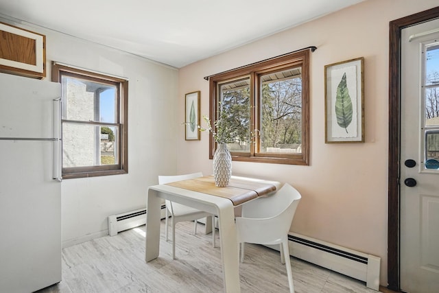 dining area with baseboard heating and baseboards