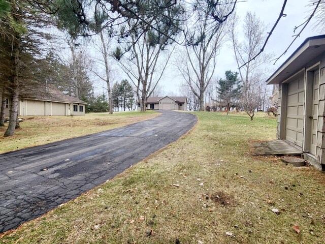 view of street featuring aphalt driveway