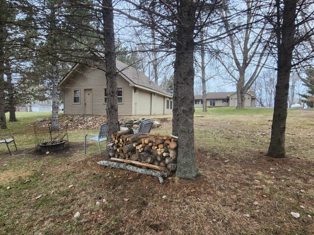 view of yard with an outdoor fire pit