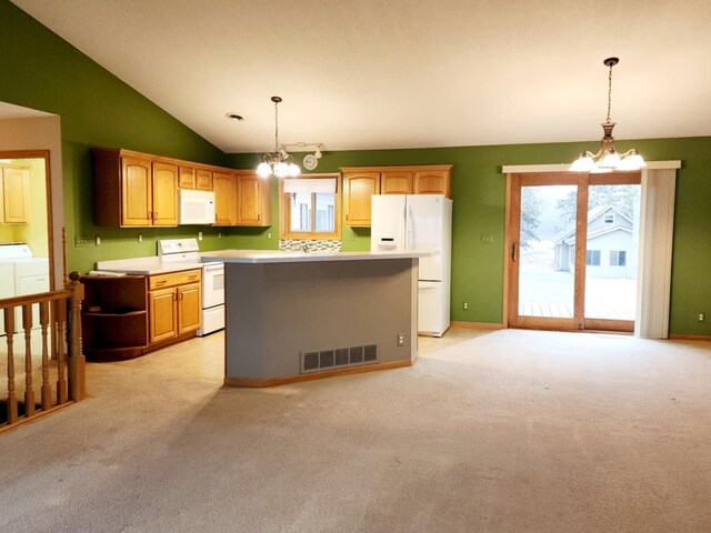 kitchen with visible vents, washer and dryer, a chandelier, and white appliances