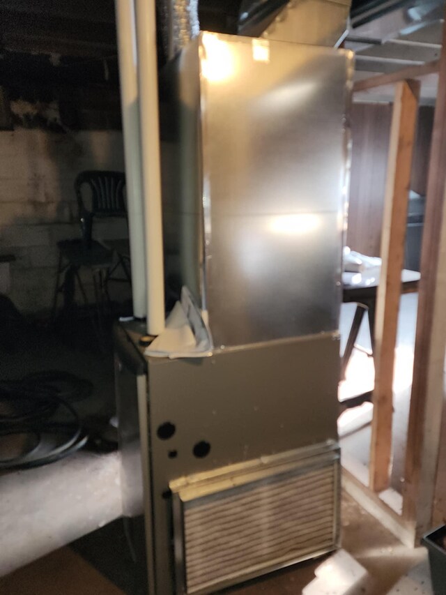interior space with concrete block wall and heating unit