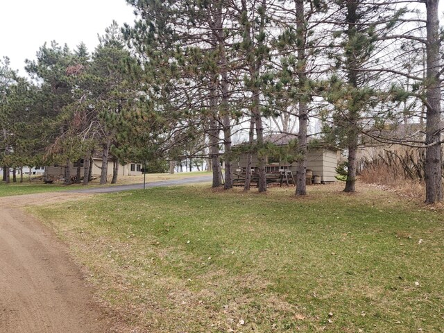 view of yard featuring aphalt driveway