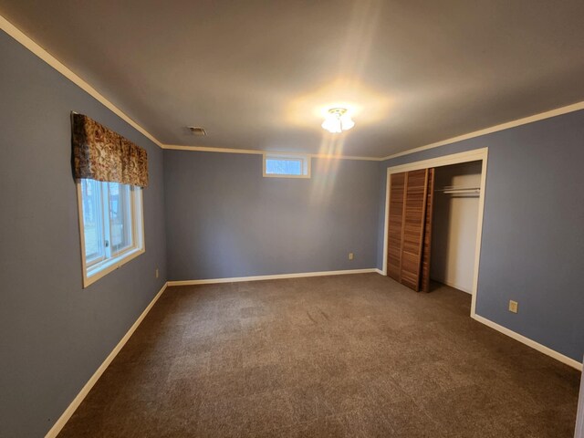 unfurnished bedroom with baseboards, ornamental molding, and carpet flooring