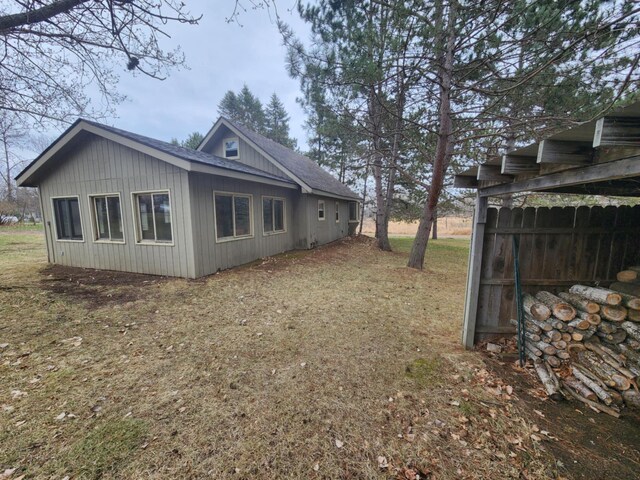 view of property exterior with roof with shingles