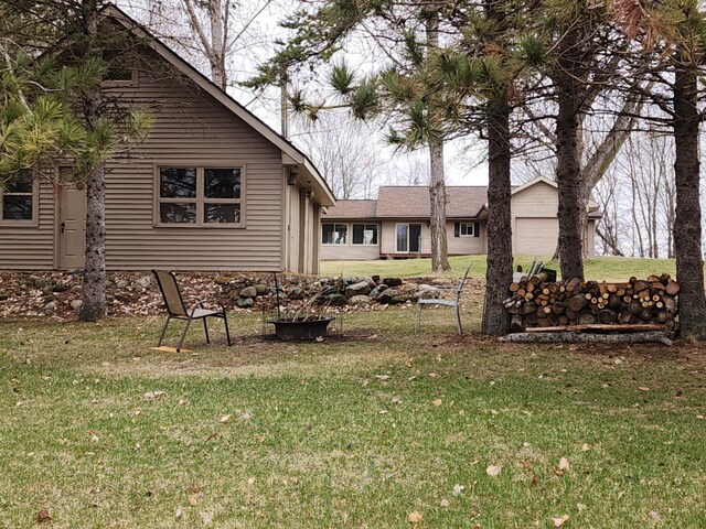 view of yard featuring a garage and an outbuilding