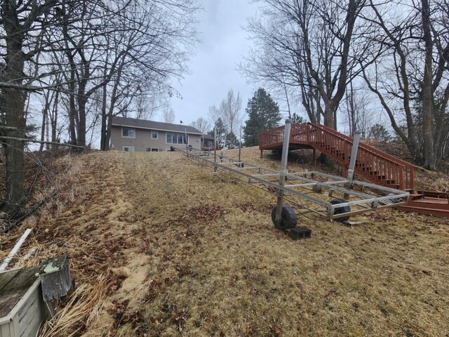 view of yard with a wooden deck and stairway