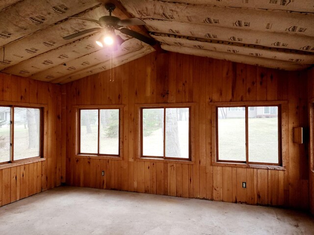 spare room with a healthy amount of sunlight, ceiling fan, and vaulted ceiling