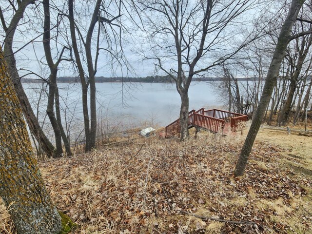 view of yard with a deck with water view