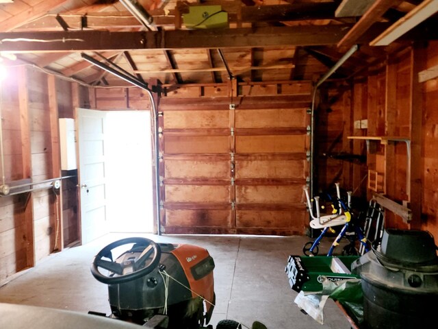 garage featuring wooden walls