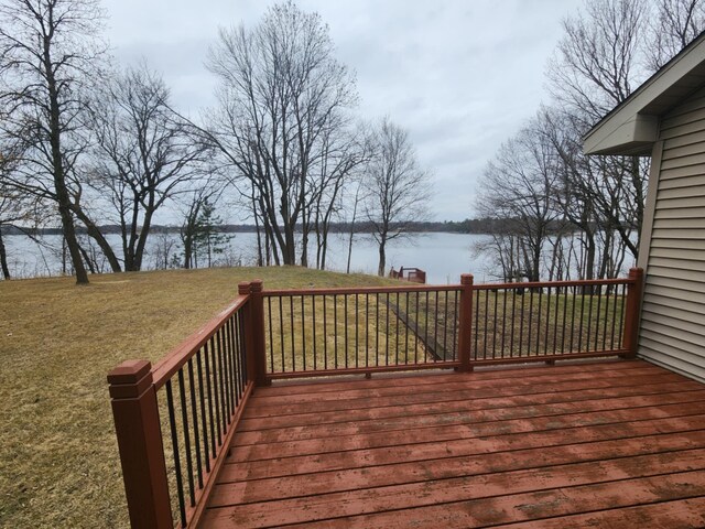 wooden deck featuring a lawn and a water view
