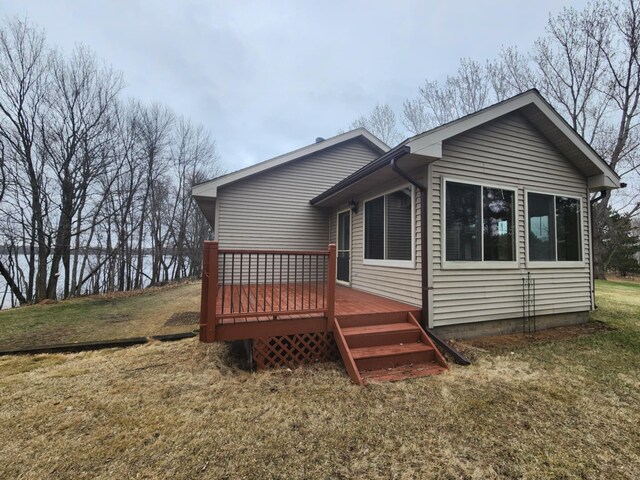 rear view of house with a yard and a deck