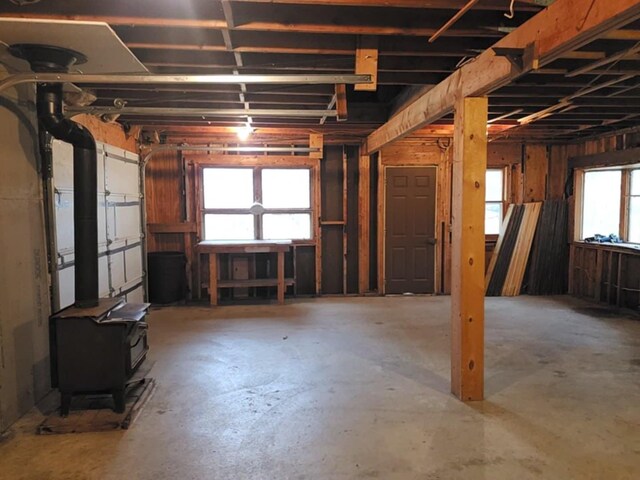 misc room featuring a wood stove and concrete flooring