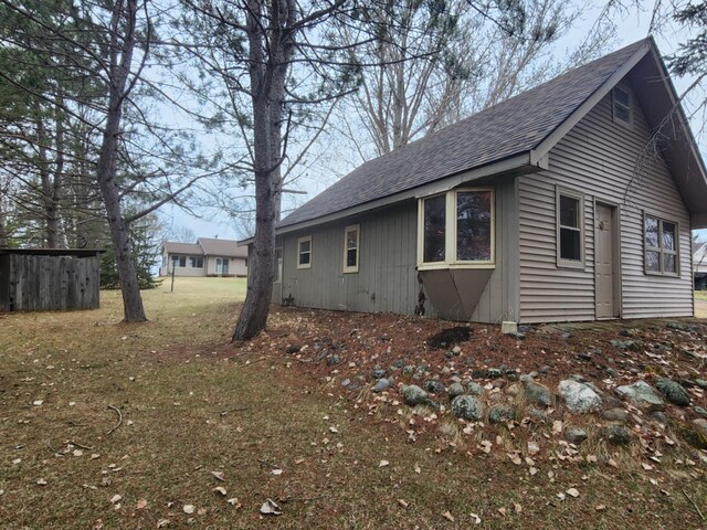 view of home's exterior featuring roof with shingles