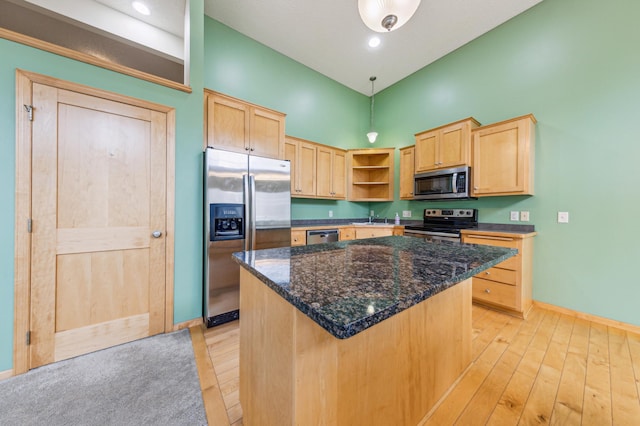 kitchen featuring light brown cabinetry, open shelves, baseboards, a high ceiling, and stainless steel appliances