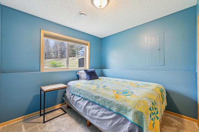 bedroom featuring a textured ceiling, baseboards, carpet, and electric panel