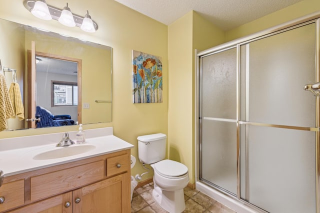 full bath with vanity, tile patterned floors, a shower stall, and toilet