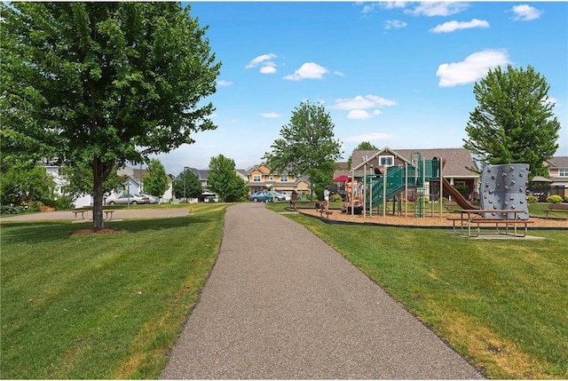 surrounding community with a yard, playground community, and a residential view