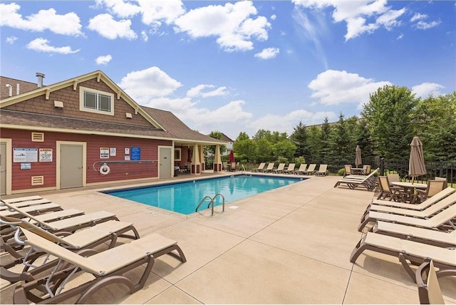 community pool featuring fence and a patio area