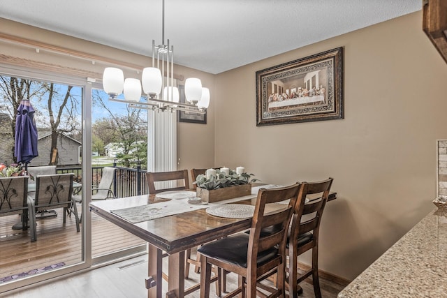 dining room with an inviting chandelier and wood finished floors