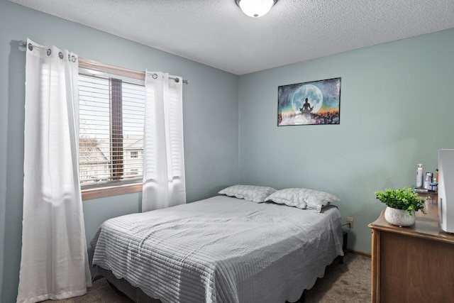 bedroom featuring a textured ceiling and carpet