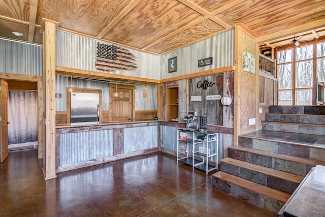 546 315th St, Cady Twp, WI 54749 - interior space featuring a ceiling fan, wood walls, wooden ceiling, built in refrigerator, and concrete floors