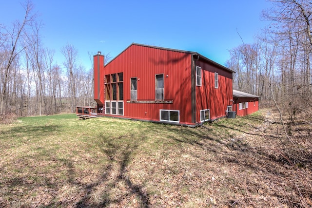 546 315th St, Cady Twp, WI 54749 - view of home's exterior featuring a yard, central AC, a chimney, and a wooden deck