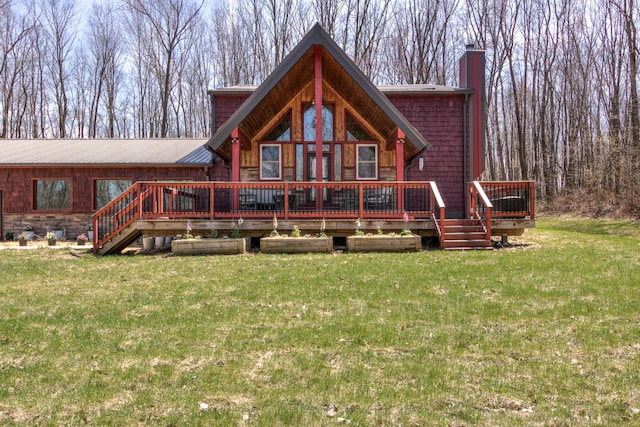 546 315th St, Cady Twp, WI 54749 - back of property with a chimney, a lawn, a deck, and a metal roof