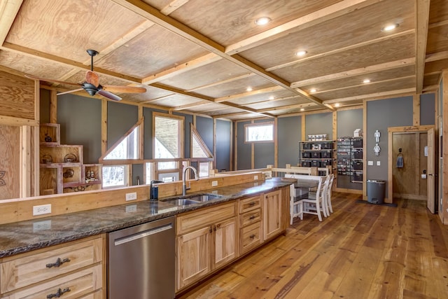 546 315th St, Cady Twp, WI 54749 - kitchen with stainless steel dishwasher, light wood-style floors, ceiling fan, light brown cabinets, and dark stone counters