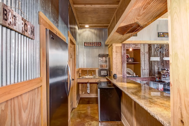 546 315th St, Cady Twp, WI 54749 - kitchen featuring stainless steel refrigerator, finished concrete floors, and light stone counters